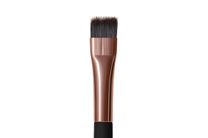 A straight makeup brush with a black handle and black bristles.